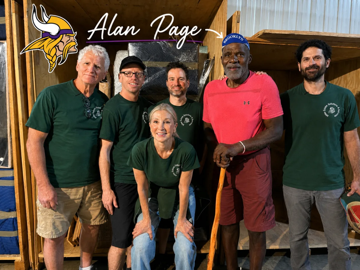 Five members of the Miller Estate Solutions team in company shirts, standing with Alan Page